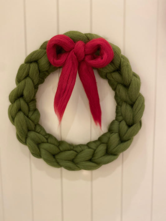 green knitted merino wreath with red bow